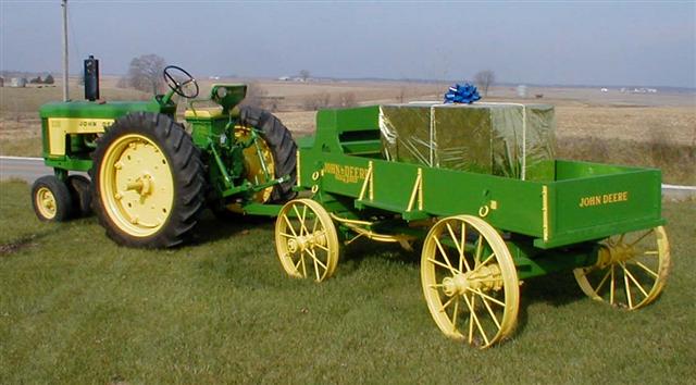 Restored John Deere Tractor with restored wooden wagon.